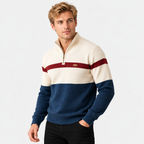 Men's half-zip color block knit sweater in cream and navy, three-quarter view on a model