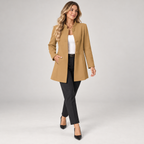 Women's collarless longline blazer with open front on a model, walking pose