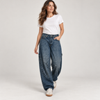 Women's retro flare pants with shimmer finish on a model, walking pose
