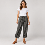 Women's tapered drawstring pants with deep pockets on a model, front view