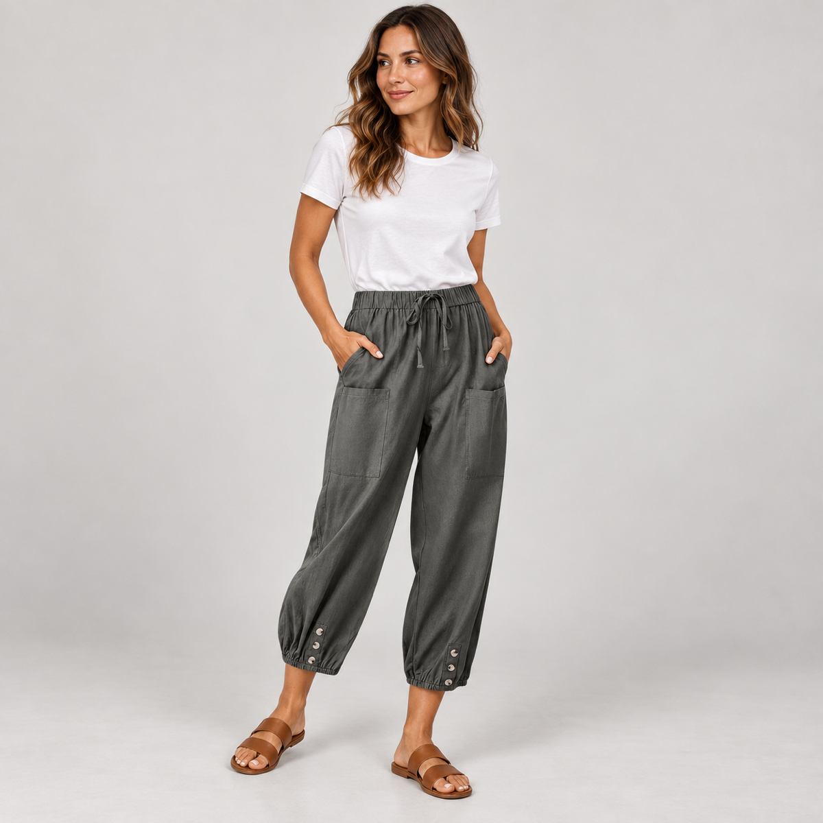 Women's tapered drawstring pants with deep pockets on a model, angled front view