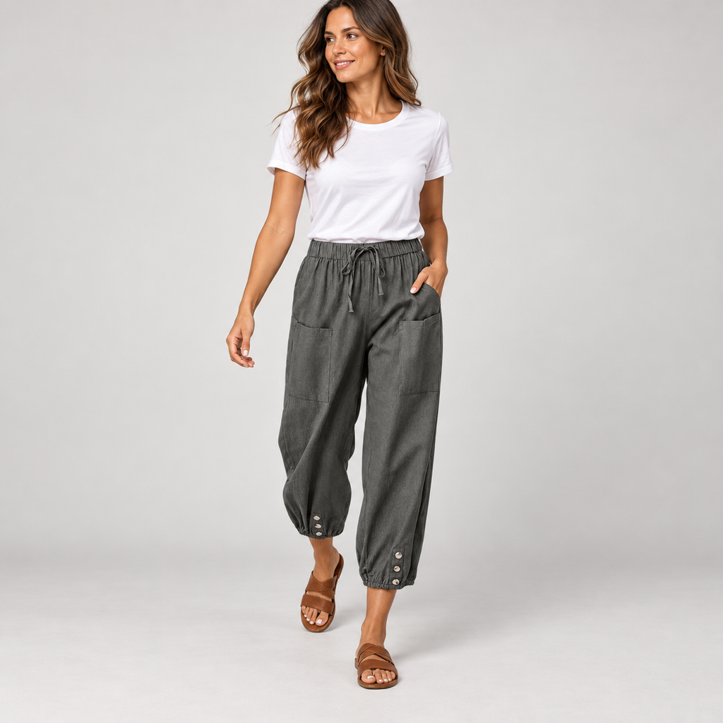 Women's tapered drawstring pants with deep pockets on a model, walking pose