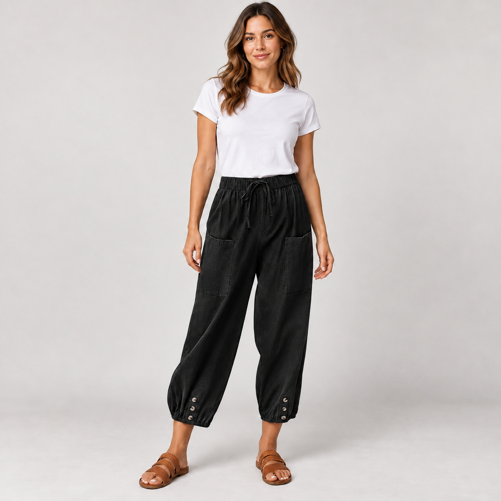 Women's tapered drawstring pants with deep pockets on a model in Black, additional studio view