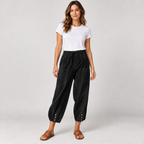 Women's tapered drawstring pants with deep pockets on a model in Black, additional studio view